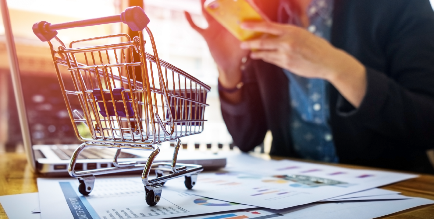 E-commerce development concept showing shopping cart with business analytics
