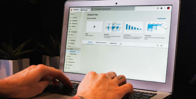 Hands on laptop screen showing dashboard and charts for data analytics and business intelligence