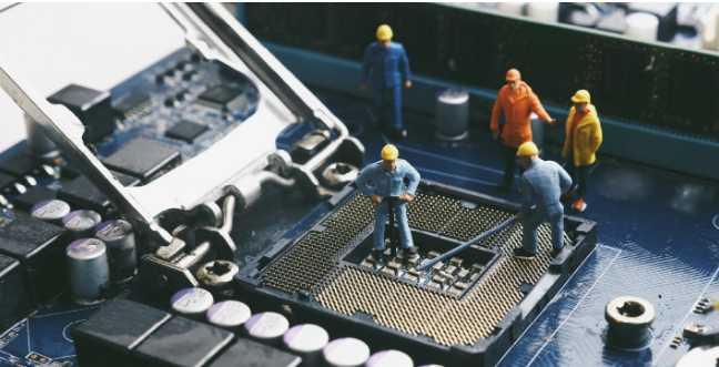 Technicians performing software maintenance on a computer chip