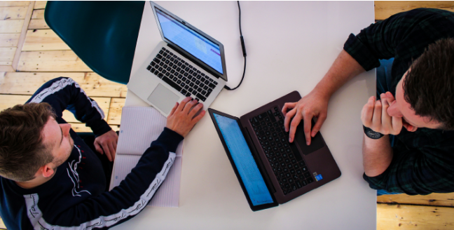 Team developing tailored software solutions on laptops